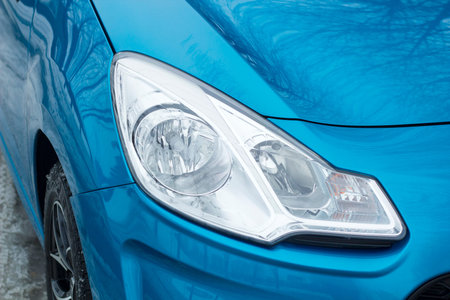 Car headlight on passenger blue carの写真素材