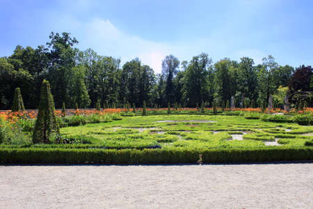 Summer garden with flowers and old statues near Wilanow royal palace, Polandのeditorial素材