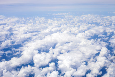 White clouds in blue sky, top view. View from airplane window