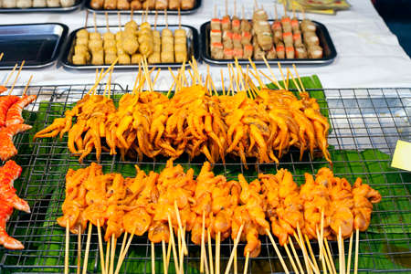 Grilled Squids on sticks on street market Phuket, Thailandの写真素材