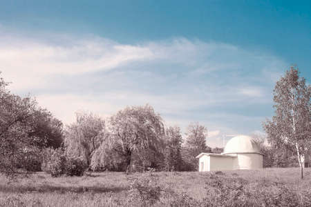 Fantasy landscape with house and woods by blue sky. Surreal fairytale garden, magic morning near enchanted dreams pink forest. Mystery spring land, white fairy home and tress aroundの写真素材