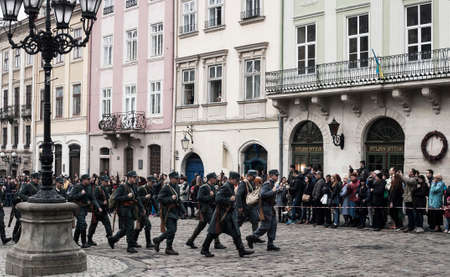 Lviv, Ukraine - 04 November 2018: Historical reconstruction of military events 1918. Fights between Poland and ZUNR (West Ukrainian People's Republic) for Lwow city. Crowd of peopleのeditorial素材