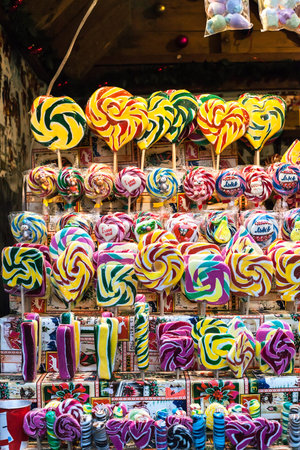 Lot of various multicolored caramel sweets sold at Christmas fair. Colorful lollipops sale in supermarket. Hard candy with inscription "Lviv"の写真素材
