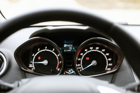 Speedometer, tachometer and fuel level in car. Black automobile instrument panel on dashboard