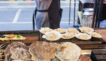 Thai healthy sea food cooking. Large Scallops grilled on street market in Phuket, Thailand