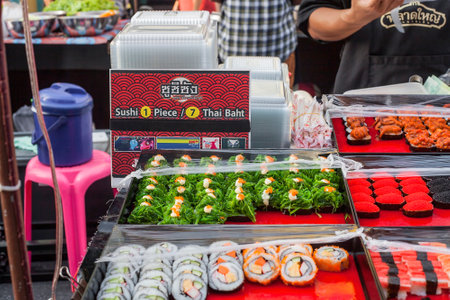 Phuket, Thailand - February 25, 2018: Various sushi selling at night street market. Variety susi with Hiyashi Wakame seaweed salad and caviar sale in outside restaurantのeditorial素材