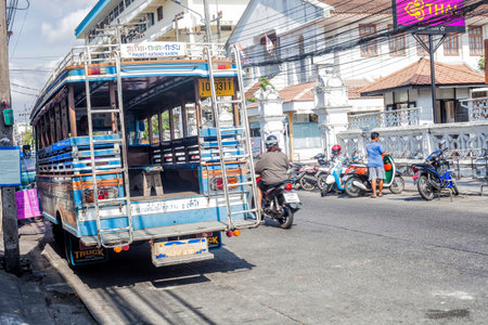 Phuket, Thailand - 26 February 2018: Street with bus, motorcyclists and local peopleのeditorial素材