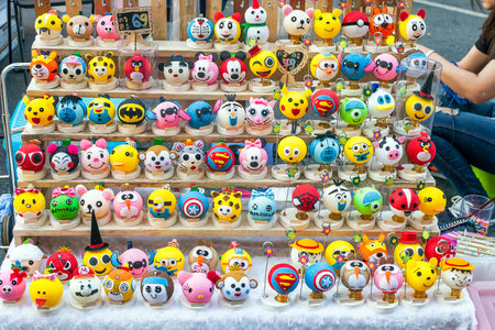 Phuket, Thailand - February 25, 2018: Threads toys of superheroes, pokemons and angry birds selling on street market. Toys-like handmade night lights for kids in Saturday Night Marketのeditorial素材