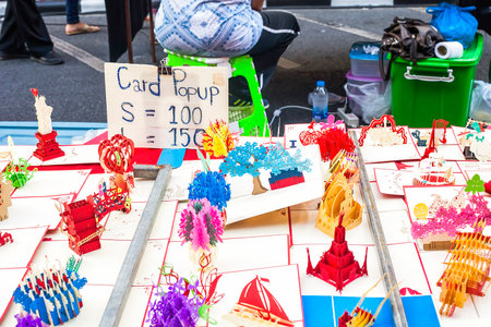 Phuket, Thailand - February 25, 2018: Paper sculptures sold in street market. Colorful cardboard popup sale. Variety toy papercraft in Kirigami styleのeditorial素材