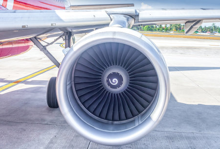 Airplane turbine and wing part. Passenger airbus waiting for departure in airportの写真素材