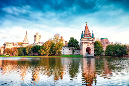 Medieval Franzensburg castle on lake in autumn Laxenburg park, Lower Austria. Water castle on artificial island in fall Schlosspark Laxenburg parkland, romantic classicism in Neogothic styleの写真素材