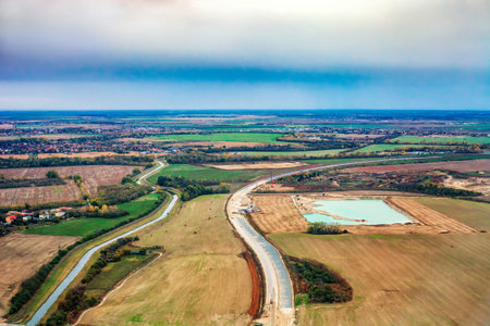 Road under construction in autumn fields near Bratislava in Slovakia, top view. Aerial view of...