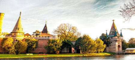 Panoramic view on autumn Laxenburg park with medieval Franzensburg castle on lake, Lower Austria....