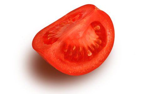 Chopped tomato slice on white backgroungの写真素材