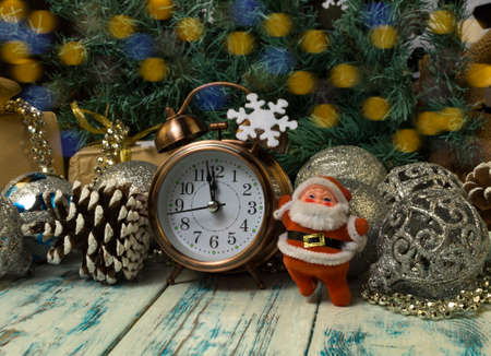 christmas toys, boxes with gifts, alarm clock on a wooden background, santa clausの写真素材