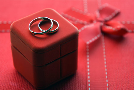 wedding rings on red box and red background