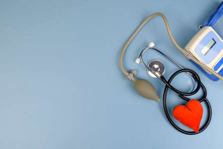 medical tonometer, heart model, phonendoscope on blue backgroundの写真素材