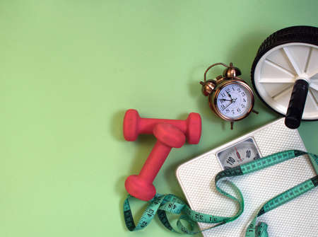abdominal wheel, dumbbells and centimeter, bathroom scales - fitness at homeの写真素材