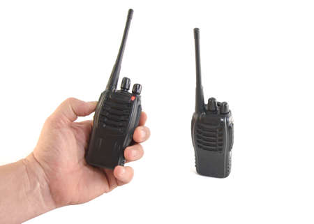 two portable radios, one in hand, on a white backgroundの写真素材