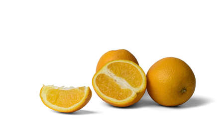 several oranges, whole and slices on a white background, close-up, isolateの写真素材