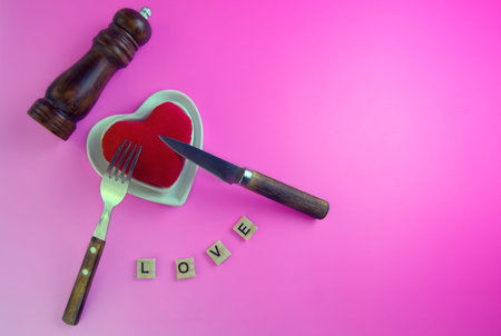 plate with a heart toy, pepper mill, cutlery, concept