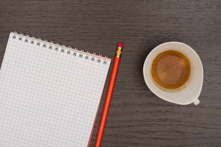 Office table with notebook, pencil and cup of coffee. View from above with copy space.の写真素材