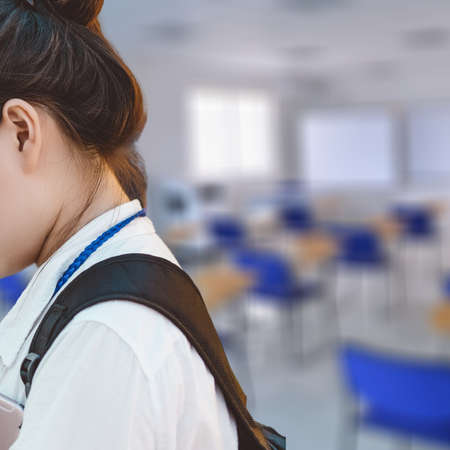 Student with backpack exiting the classroomの写真素材