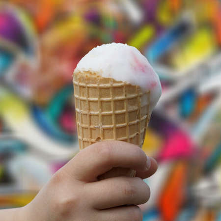 Child holding ice melted ice cream coneの写真素材