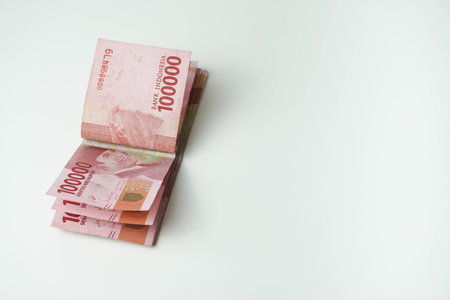 pile of indonesian money (Rupiah) on white background. one hundred thousandの写真素材