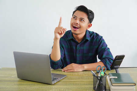 Joyful young asian man sit work at wooden desk with pc laptop. Achievement business career lifestyle...