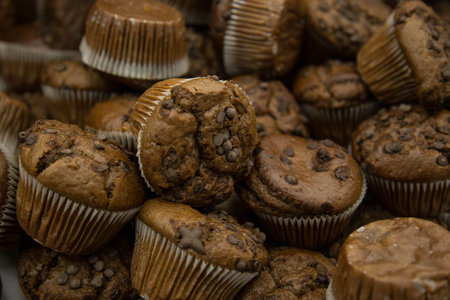 Several chocolate muffins with chocolate chips close up