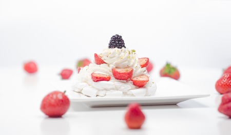 light dessert with cream and plum with strawberries and blueberriesの写真素材