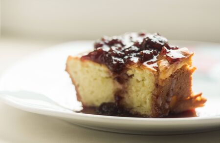 a piece of homemade pie on a plate with berry jam from strawberriesの写真素材