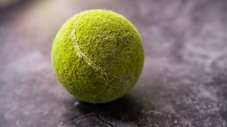 Old shabby and dusty green tennis ballの写真素材