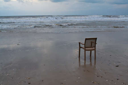 A lonely plastic chair on the beachの写真素材
