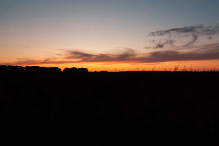dark sunset silhouette of the earth the horizon and the red sky gradientの写真素材