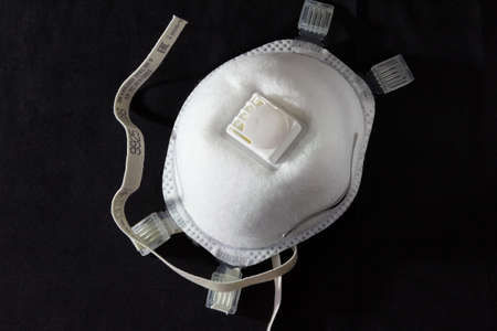 Medical mask, Medical protective mask on black background. Disposable surgical face mask cover the mouth and nose.の写真素材