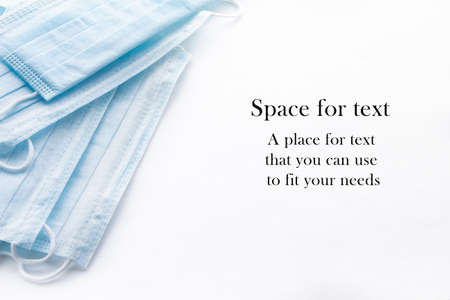 Disposable surgical face mask cover the mouth and nose. Medical protective mask on wight background. Spase for textの写真素材