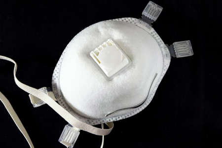 Medical mask, Medical protective mask on black background. Disposable surgical face mask cover the mouth and nose.の写真素材