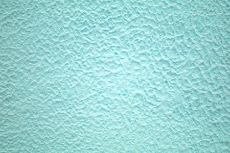 concrete wall of light blue color, texture turquoise cement background