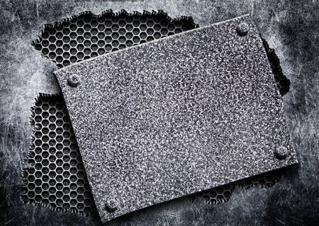 metal plate nailed to the grid iron in hole steel sheetの写真素材