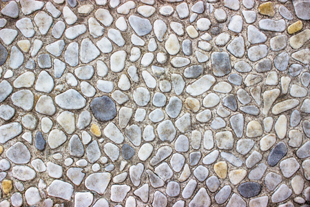 Decorative stone wall texture of the small boulders as backgroundの写真素材