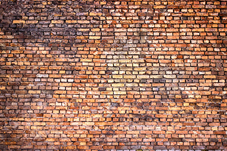 red brick wall, urban exterior, ancient weathered surfaceの写真素材