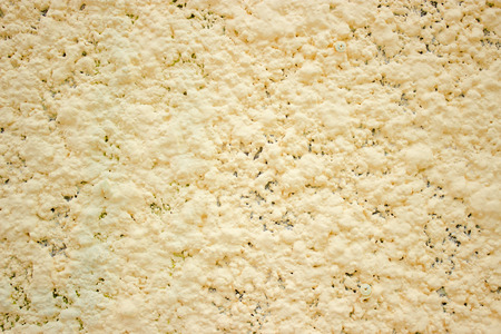 concrete wall painted yellow paint, Texture colored cement as backgroundの写真素材