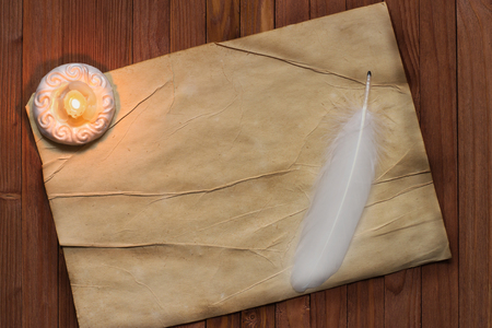 Old blank antique scroll paper on table with quill pen and candleの写真素材