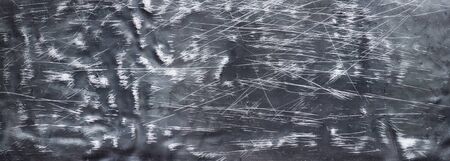 Crumpled black metal texture, shabby steel backdrop of high resolutionの写真素材