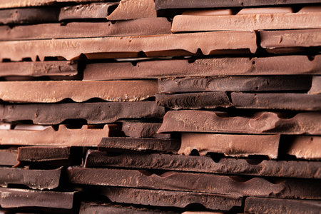 stack of broken chocolate bars, sweet background
