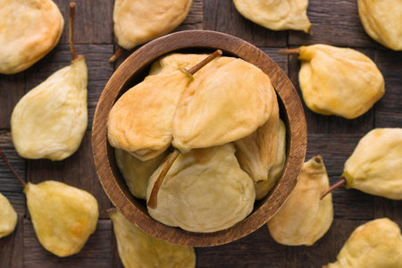 dried fruit, pears whole in bowl on wooden table background.