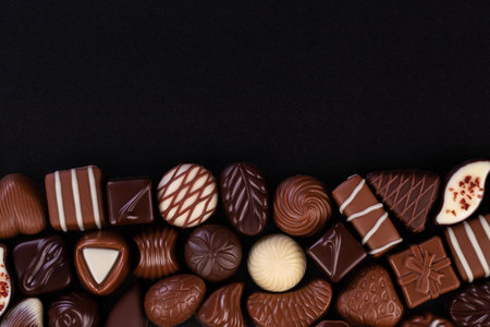 mix chocolate candy and other sweetness on blackboard background, sweet food frameの写真素材