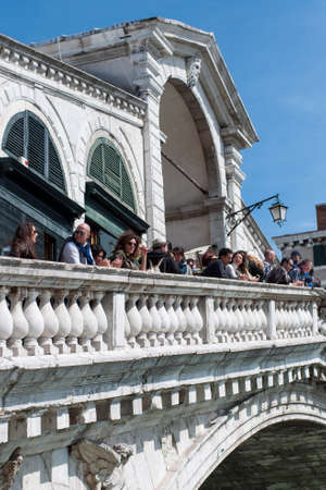 VENICE, ITALY - APRIL 13, 2013: Tourists talk to each other on the Rialto Bridge, Grand Canalのeditorial素材